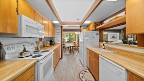 Galley kitchen stocked with all of your cooking needs