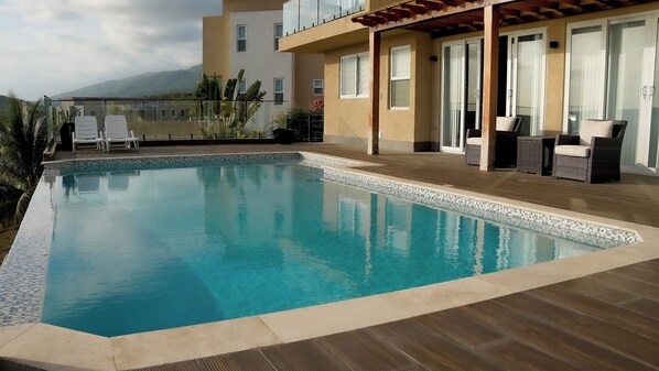 Pool deck area with comfortable sofa chairs