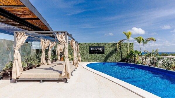 Relax in the shaded cabana by the pool.