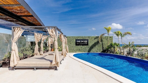 Relax in the shaded cabana by the pool.