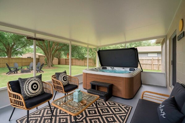 Relax in the hot tub or by the fire pit both with cozy seating and soft lights.