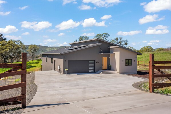 Exterior view of property entrance with two-car garage. 