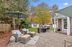 Main patio with teak dining table and bbq