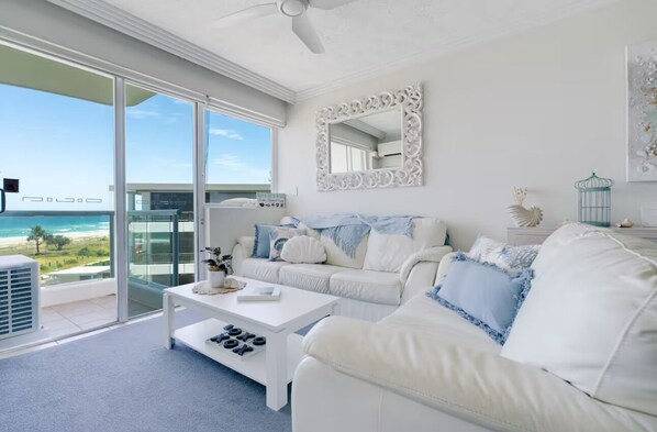 Living area with Beach views and balcony access