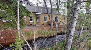 Front of farmhouse from across the creek