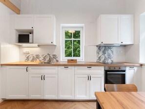 Flooring, Cabinetry, Wood, Kitchen, Interior Design, Countertop, Floor, Furniture, Kitchen Appliance, Home
