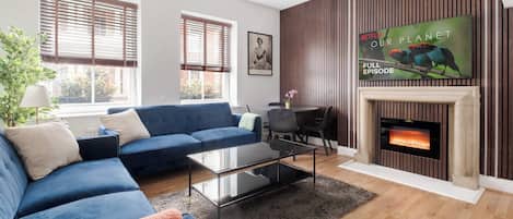 Serene lounge with wood panels, LED lighting and 65-inch smart TV