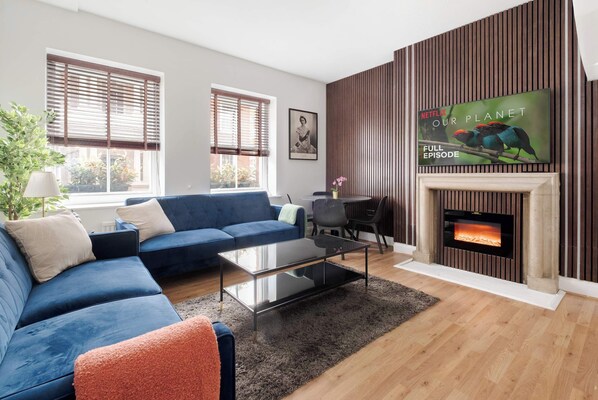 Serene lounge with wood panels, LED lighting and 65-inch smart TV