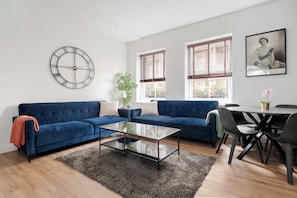 Serene lounge with wood panels, LED lighting and 65-inch smart TV