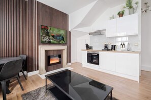 Serene lounge with wood panels, LED lighting and 65-inch smart TV