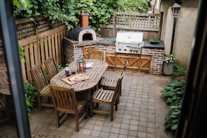 Dining area pack patio with grill and pizza oven