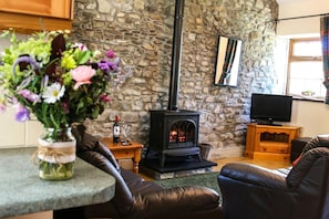 Lounge with woodburner, sofa, armchair, tv