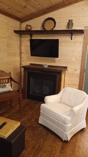 Fireplace and shelf made from oak milled from the property. Gas logs for winter 