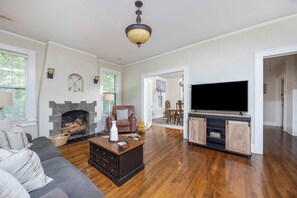 Relax in this comfortable living room equipped with Smart TV, games, and books