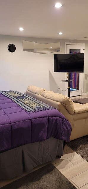 Smart TV can be used at foot of bed, in front of sofa, or as extra monitor