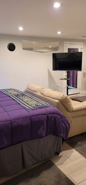 Smart TV can be used at foot of bed, in front of sofa, or as extra monitor