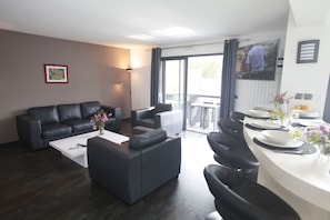 Spacious and cozy living room with direct access to the terrace—perfect for relaxing after a beach day.