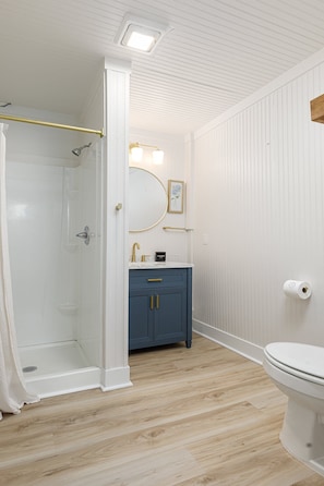 Designed with a blend of classic and contemporary elements, this bathroom offers a revitalizing experience with ample light and thoughtful touches.