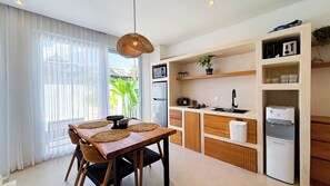 Modern kitchen with gas stove, fridge, and appliances – Villa Balinay