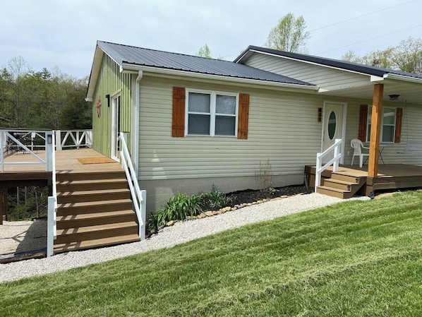 Deck stairs lead to the sliding door for the kitchen