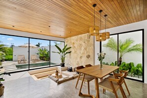 Enclosed living area with AC, smart TV, and sofa – Villa Levante