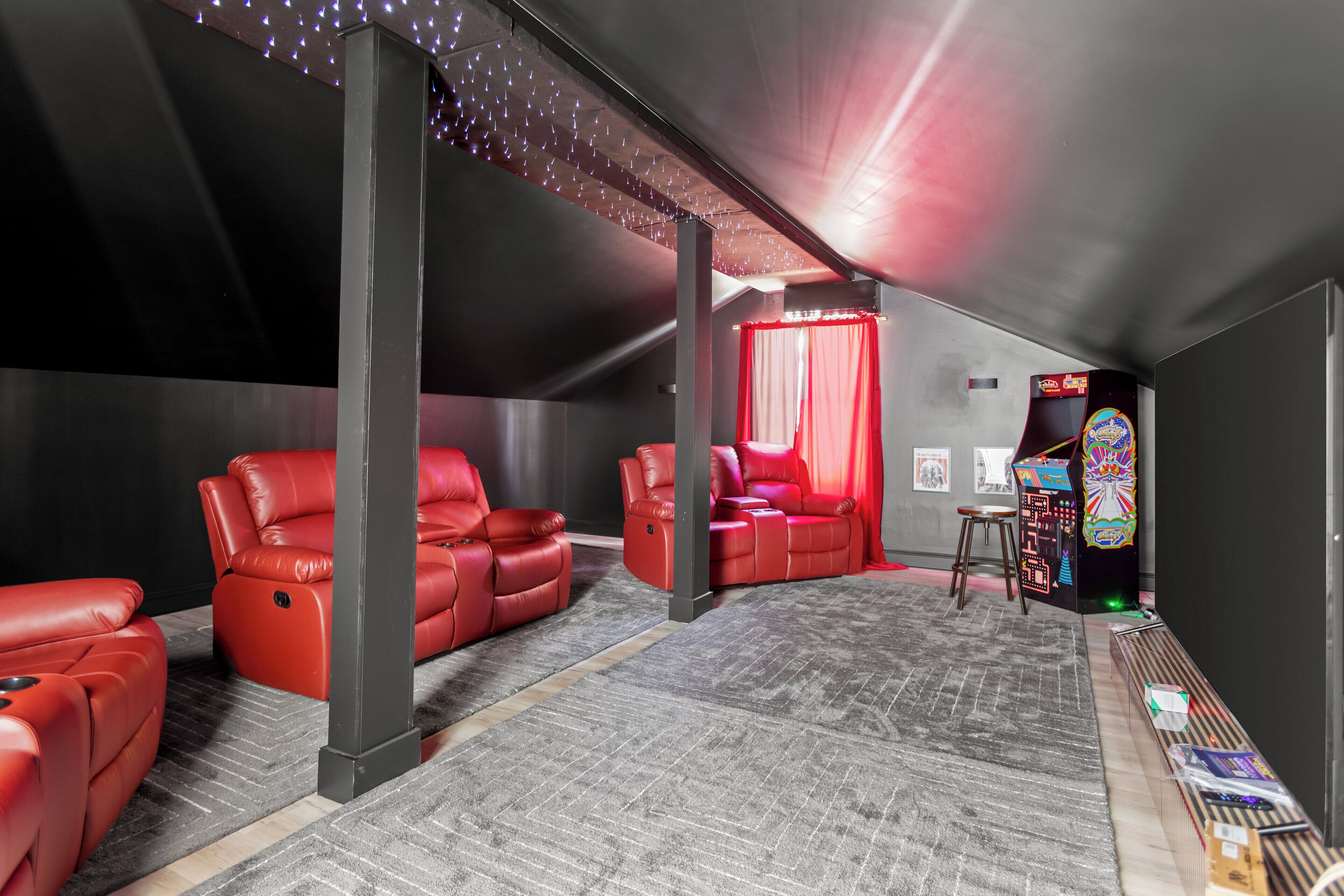 Lights, camera, relax! This cozy hideaway brings the cinema home with plush recliners, a massive screen, and even an arcade corner for a dose of retro fun. Perfect for family nights, gamer getaways, or binge-watching marathons.