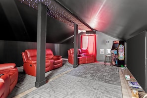 Lights, camera, relax! This cozy hideaway brings the cinema home with plush recliners, a massive screen, and even an arcade corner for a dose of retro fun. Perfect for family nights, gamer getaways, or binge-watching marathons.