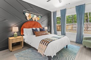 Wake up refreshed in this design-forward sanctuary featuring a statement wall, luxe linens, and tons of natural light. With earthy textures, playful pops of color, and peaceful views, this room is your dreamy retreat after a day of exploring.