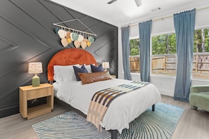 Wake up refreshed in this design-forward sanctuary featuring a statement wall, luxe linens, and tons of natural light. With earthy textures, playful pops of color, and peaceful views, this room is your dreamy retreat after a day of exploring.