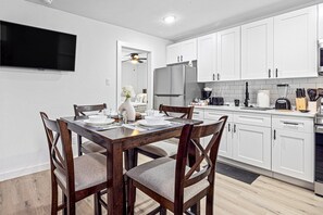 Charming dining table that sits 4 with full tableware and silverware included.