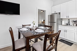 Charming dining table that sits 4 with full tableware and silverware included.