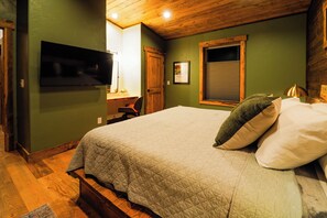 A Cozy Retreat After a Day of Adventure
This king bedroom blends rich wood, restful tones, and a plush bed you’ll sink into after long days exploring Yellowstone or the rodeo. A built-in desk offers a quiet corner for writing postcards, journaling, or catching up before bed.
