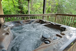 Soak your cares away in the bubbling hot tub while taking in the peaceful forest views—your private mountain retreat awaits just steps from the cabin.