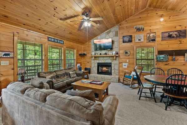 Snuggle up by the fire in this cozy living room, where bear-themed décor and soft seating invite you to relax after a day of Smoky Mountain adventures.