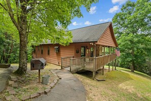 Welcome to Mama Bear Cabin—a charming mountain retreat where rustic charm meets modern comfort, all nestled beneath a canopy of green.