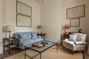 Grooms Cottage - the living area with old maps of the estate on the walls
