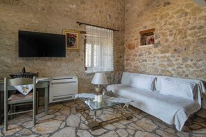 Living Room with Stone Fireplace and TV
A charming space combining rustic tradition with modern amenities.