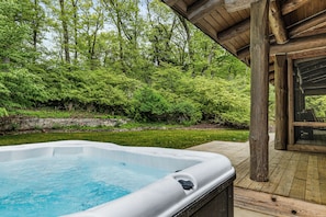 Dip into warm soak in the hot tub, surrounded by the beauty of the woods.