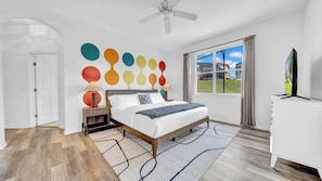 Bedroom with plush beddings and ceiling fan