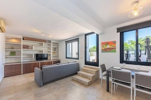 Bright space with sofa, TV and direct access to the terrace. (2)
