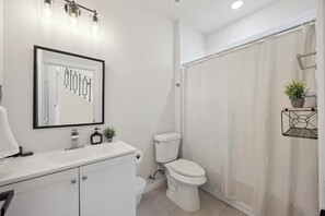 Ensuite bath w/ fresh towels, toiletries & spacious shower for your comfort.