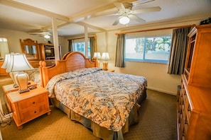 Rest peacefully in the king bedroom suite, featuring soothing decor, ample storage, and windows that let in refreshing ocean breezes.