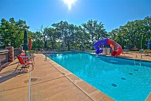 Enjoy a sunny day splashing around in this expansive pool, complete with playful waterslides and scenic views of the surrounding nature.