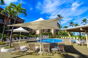 Relax by the inviting resort pool surrounded by lush tropical landscaping and comfortable lounge chairs, perfect for sunny days in Maui.
