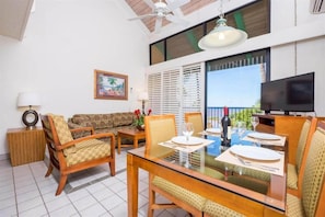 A welcoming living space featuring comfortable seating, vibrant decor, and stunning views through expansive windows.
