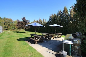 Step onto the patio and breathe in fresh air, overlooking a manicured lawn perfect for a picnic or playtime.