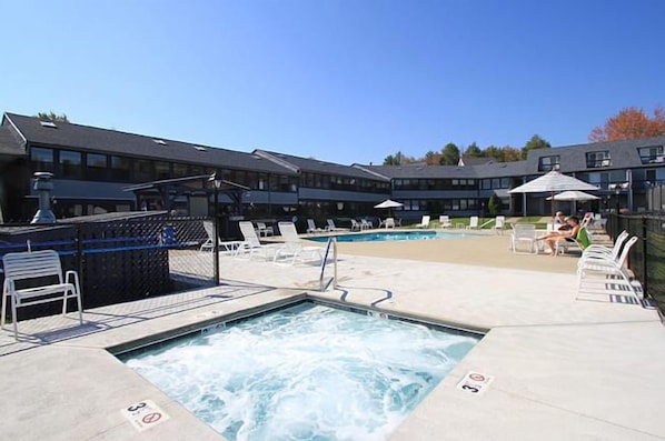 Unwind in the inviting outdoor hot tub while soaking in serene views of the contemporary resort setting.