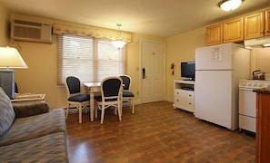 Stylish open-concept living room with wood finishes, a plush couch, and smart TV — your cozy home base.