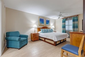 This cozy bedroom features a comfortable queen bed, perfect for family relaxation after a beach day, complete with a scenic partial ocean-view balcony.