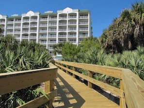 An inviting boardwalk leads you straight from your accommodations to pristine beach access surrounded by tropical foliage.